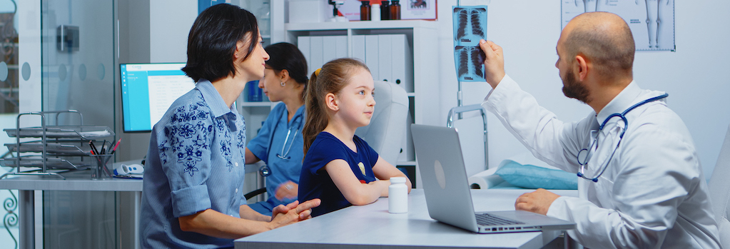 Doctor and patients looking at x-ray sitting in medical office. Physician specialist in medicine providing health care services consultation, radiographic treatment in clinic hospital cabinet